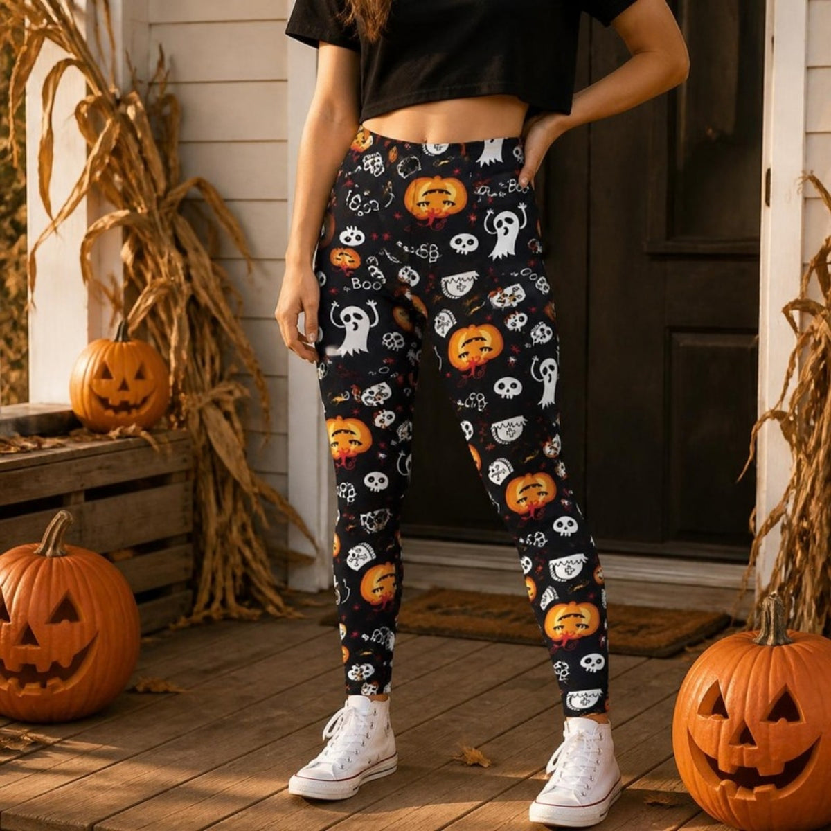Pumpkin & Ghost Halloween Leggings styled with a black crop tee and white sneakers on an autumn porch (AI-styled image)