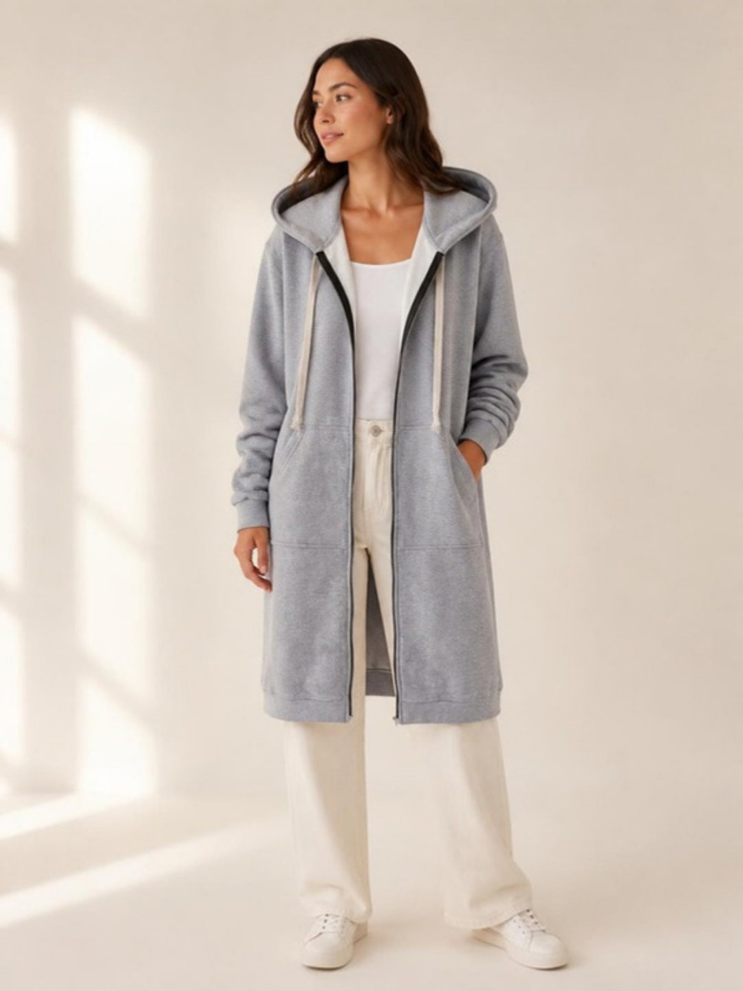 The Hooded Longline Zip Coat in grey, studio view