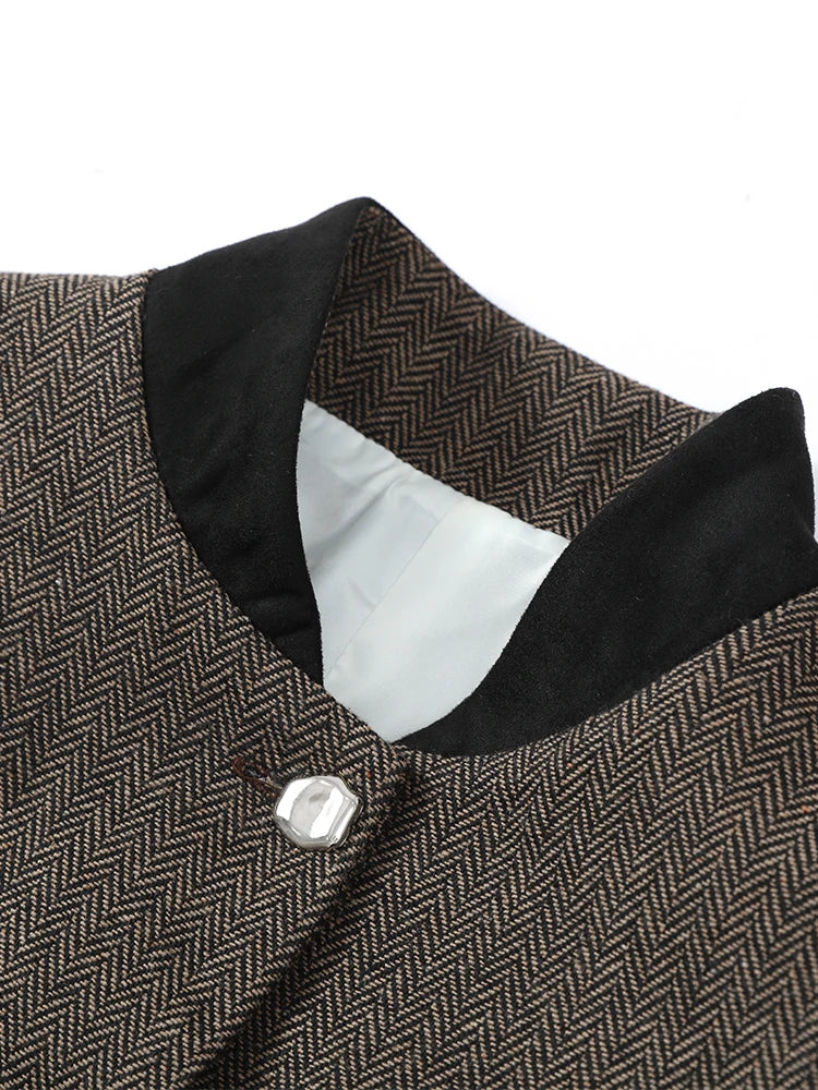 Grey herringbone jacket collar and button detail