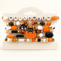 AI-styled studio photograph of the exact Halloween Cat & Pumpkin Bead Bracelets — Set of 6; front view.