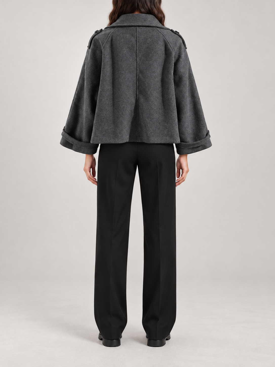 charcoal oversized boxy short jacket with relaxed raglan sleeve, front zip/placket, cuff tabs and broad foldable collar, back view on a model