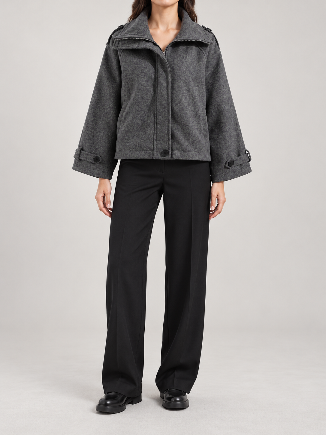 charcoal oversized boxy short jacket with relaxed raglan sleeve, front zip/placket, cuff tabs and broad foldable collar, front view on a model