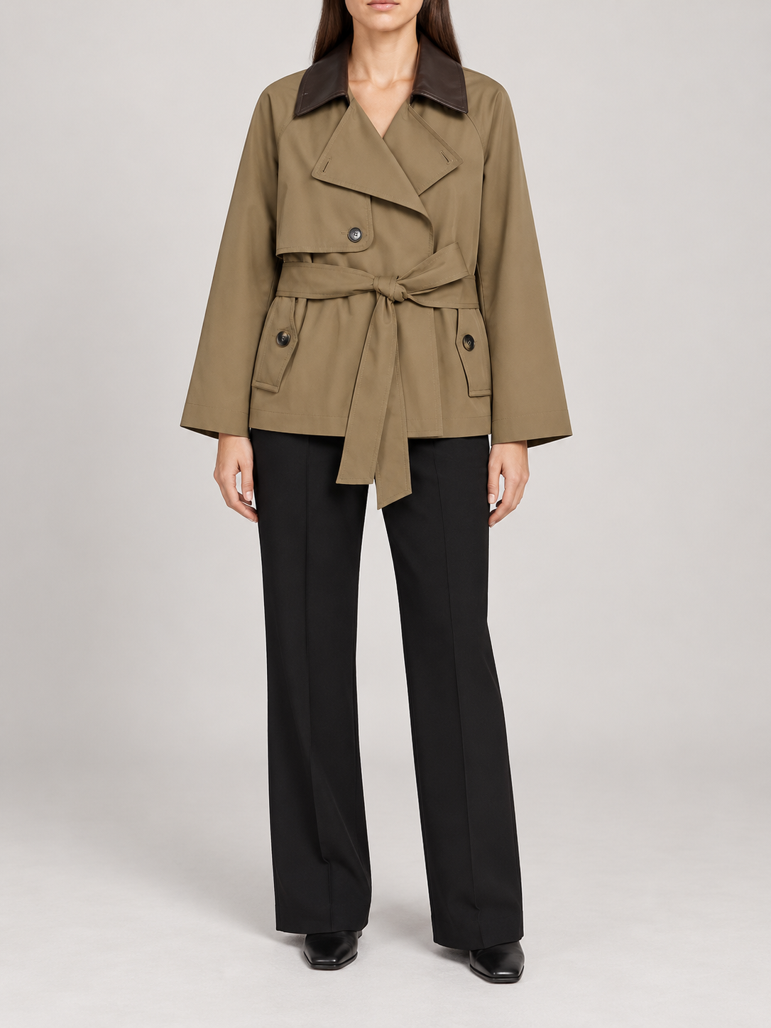 olive-khaki short belted trench with dark brown leather-look contrasting collar, broad lapels, buttoned flap pockets, front view on a model