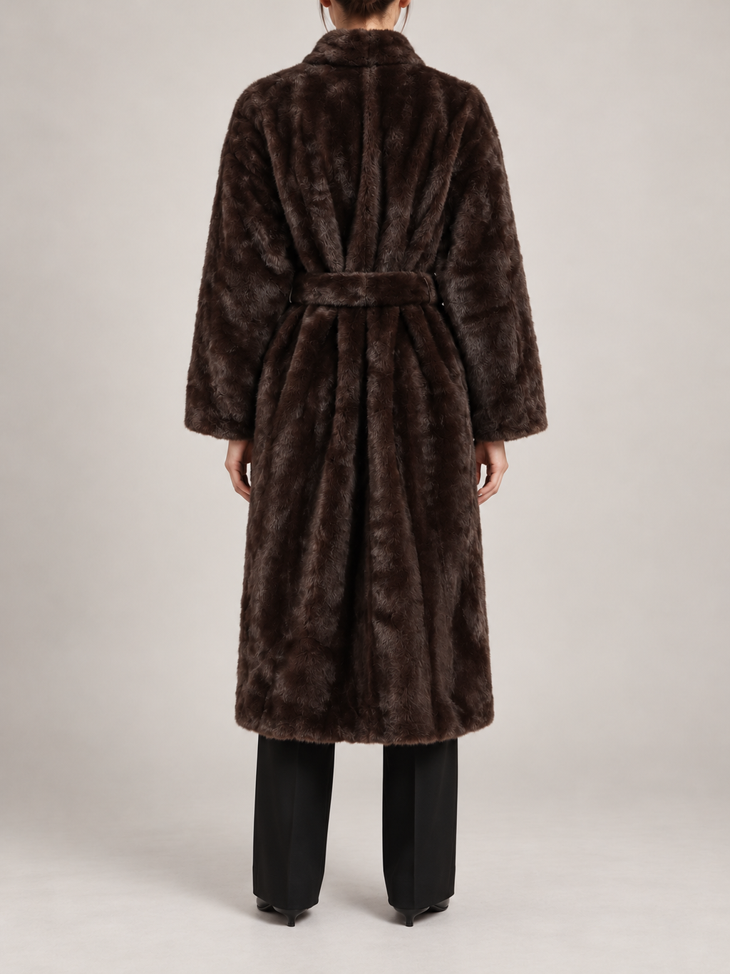 dark brown long faux-fur wrap coat with matching waist tie, slim rounded shawl collar, broad straight sleeves, back view on a model