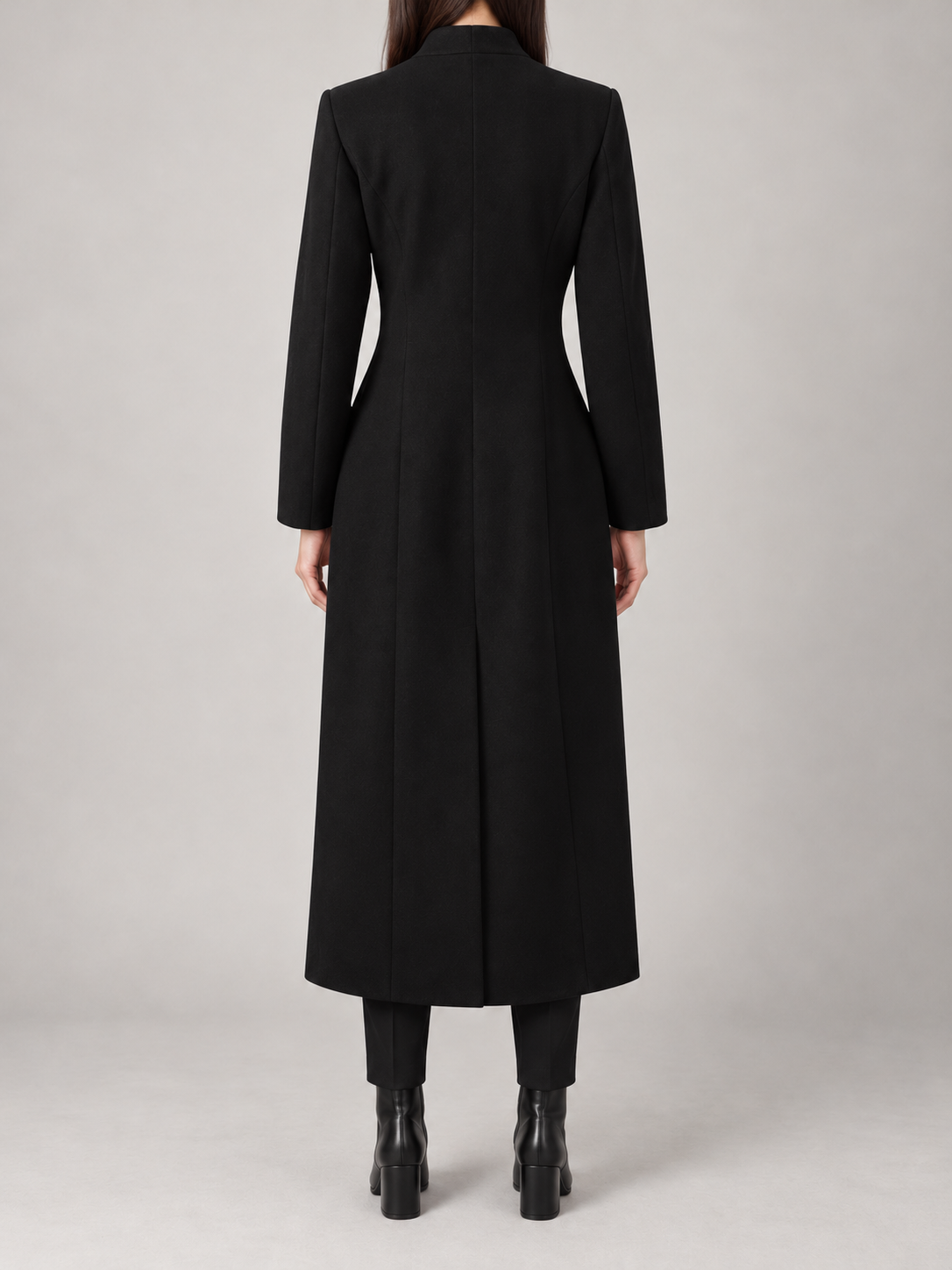 Black long tailored coat on a model, back view