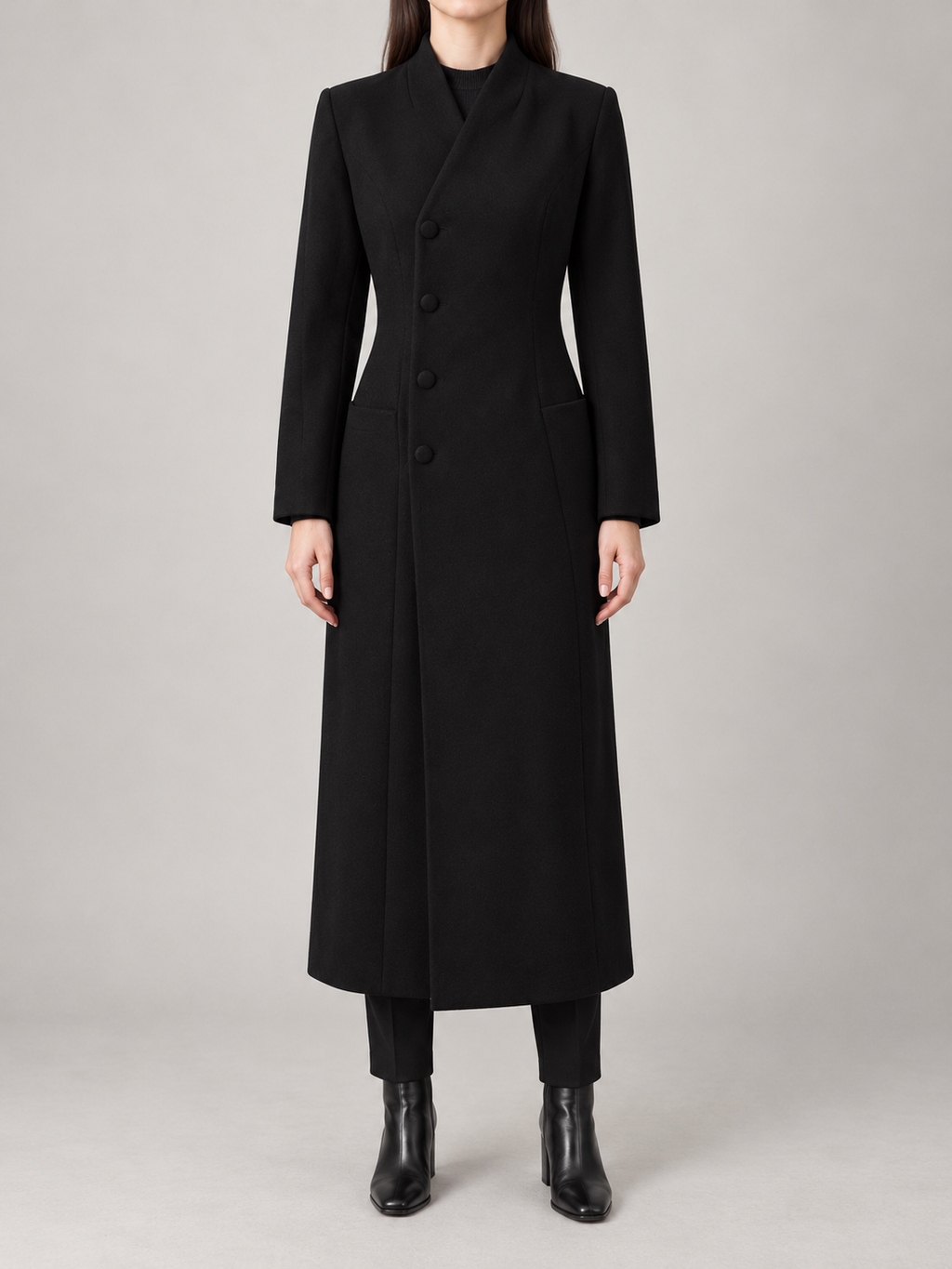 Black long tailored coat on a model, front view