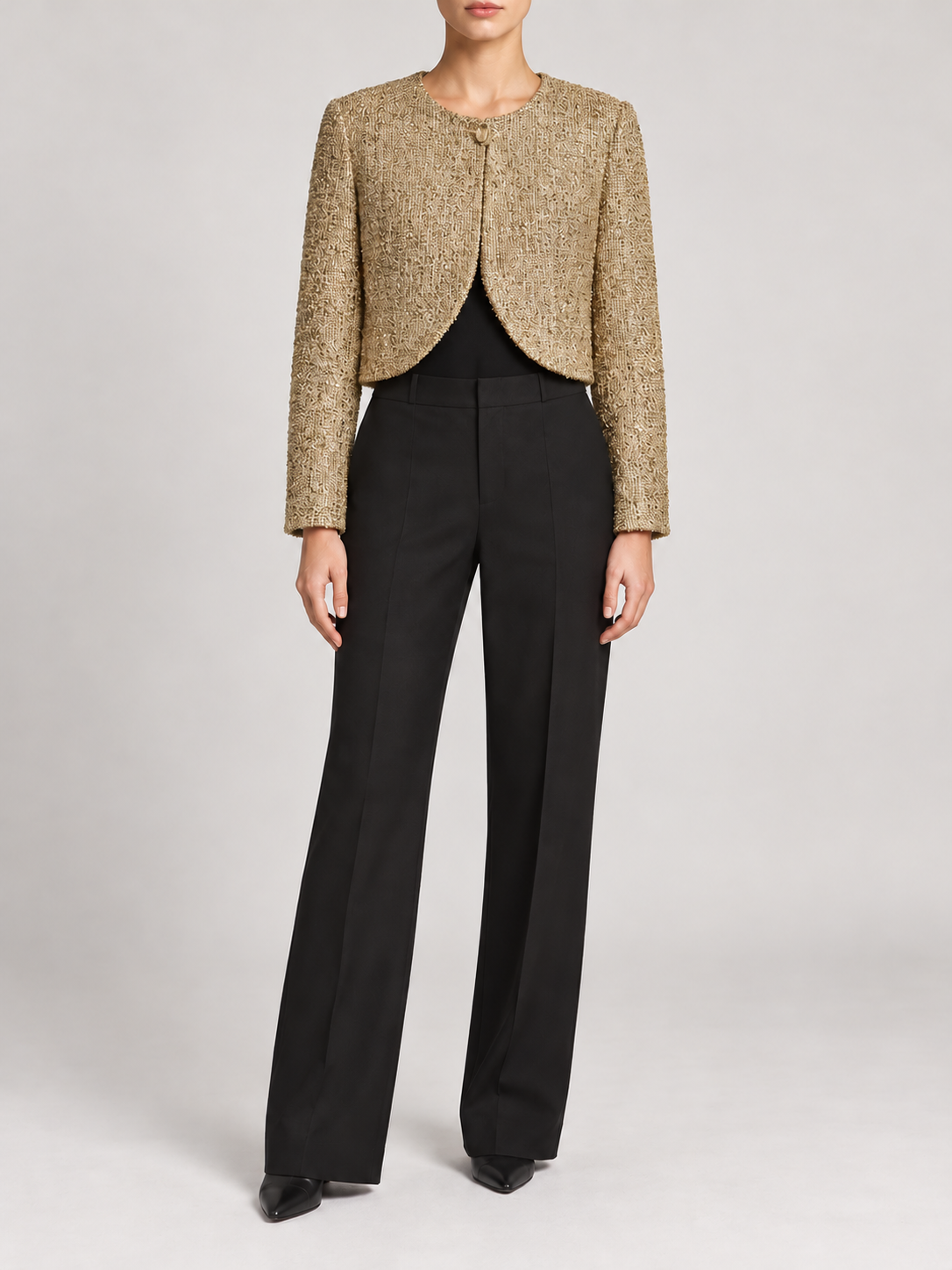gold metallic tweed cropped round-neck jacket with one top fastening and curved open front, front view on a model