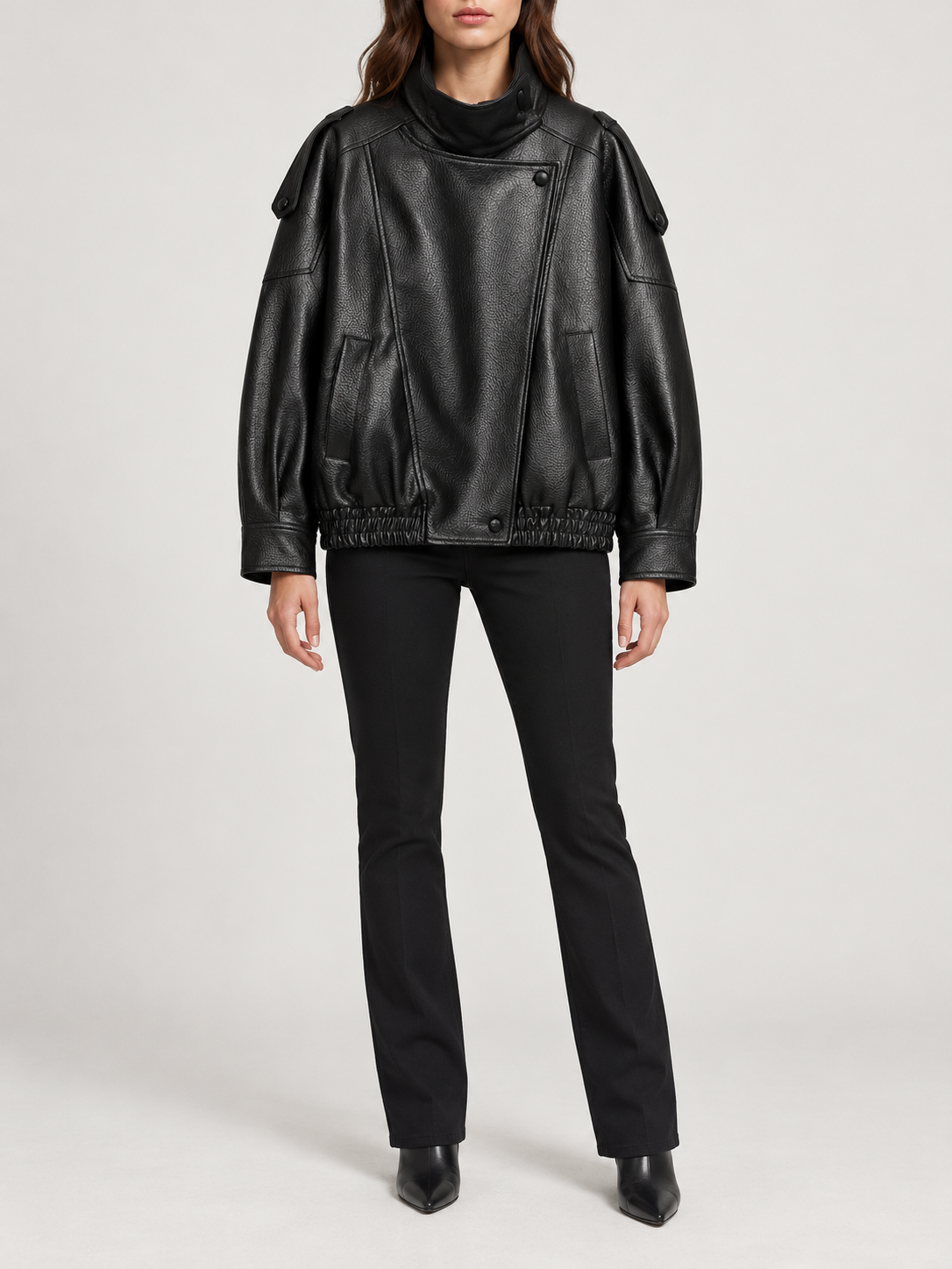 black oversized leather-look bomber with high stand collar and elastic hem, front view on a model