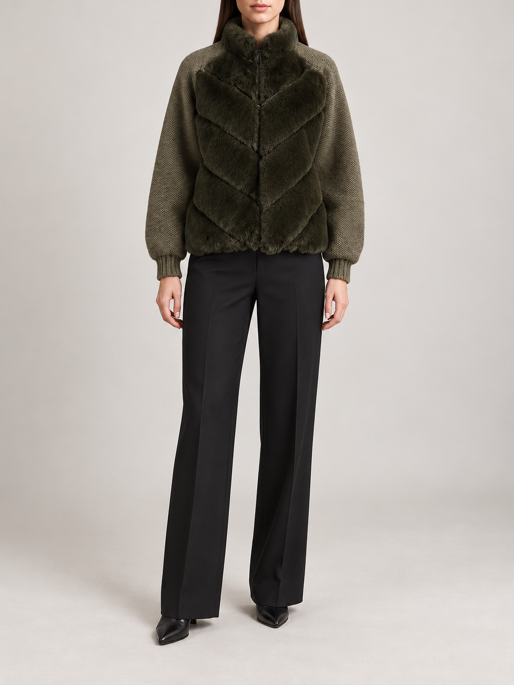 dark olive short jacket with chevron faux-fur body panels, olive knitted sleeves and ribbed cuffs, front view on a model