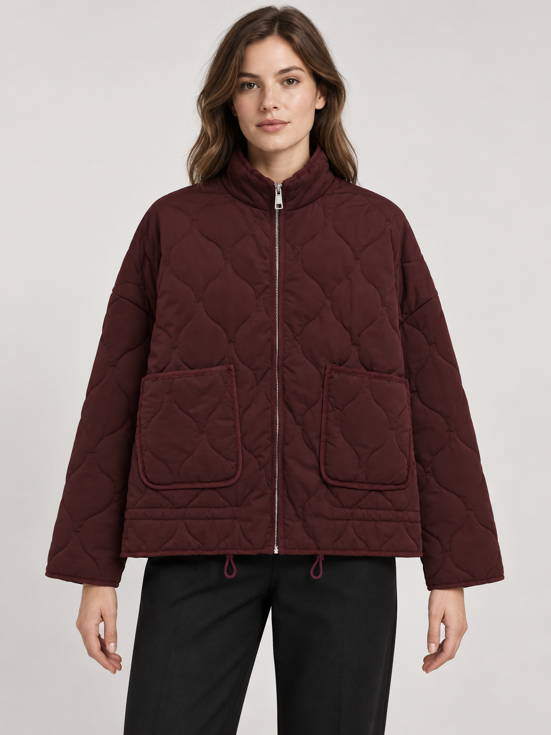 Burgundy quilted zip jacket with two patch pockets, front view