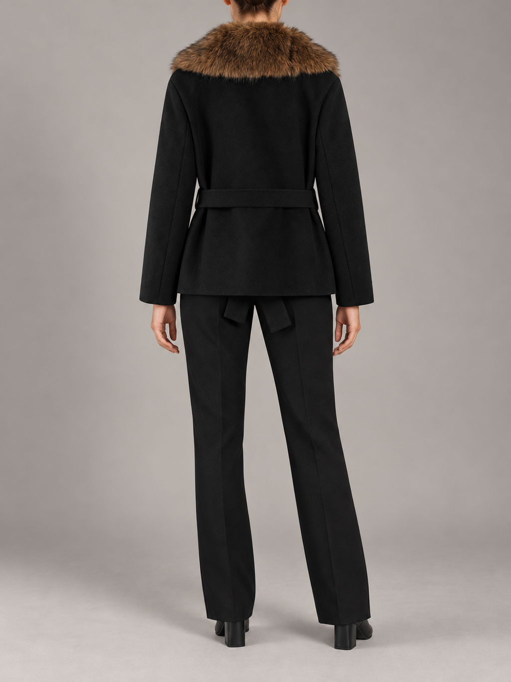 black short belted coat with brown segmented faux-fur shawl collar, straight sleeves and fabric waist tie, back view on a model