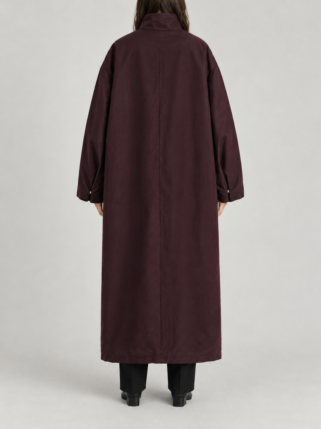 dark plum oversized ankle-length high-neck trench, concealed placket and very wide dropped shoulder sleeves, back view on a model