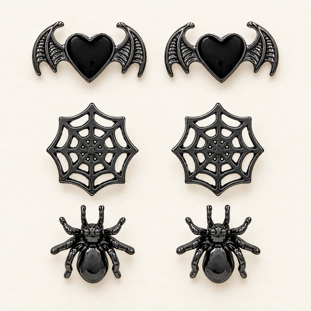 AI-assisted front view of the complete three-pair Halloween earring set: bats, webs and spiders